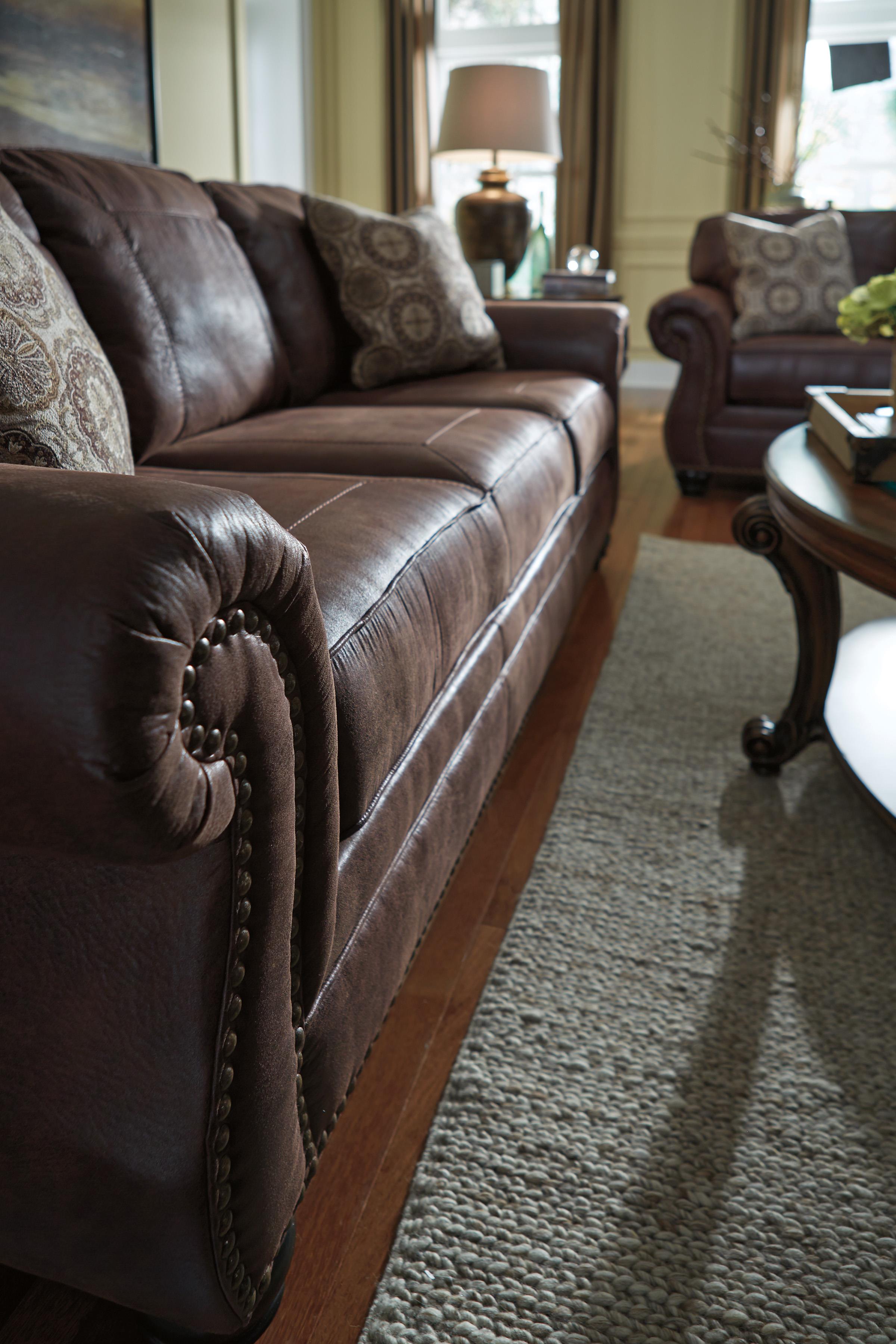 Benchcraft Breville Faux Leather Sofa with Rolled Arms and Nailhead